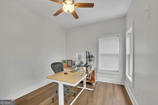 office with baseboards, wood finished floors, and a ceiling fan