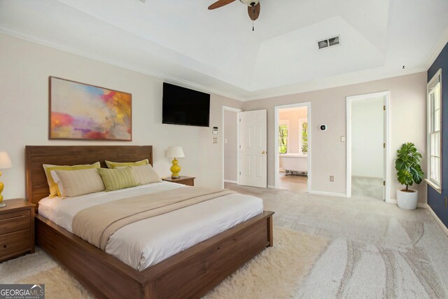 bedroom featuring light colored carpet, ornamental molding, visible vents, a raised ceiling, and baseboards
