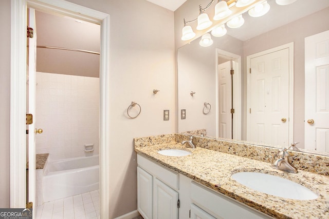 full bath featuring double vanity, a sink, and washtub / shower combination