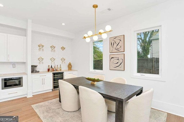1598 Athens Ave SW, Atlanta, GA 30310 - dining space featuring wine cooler, healthy amount of natural light, bar area, light wood-style flooring, and recessed lighting