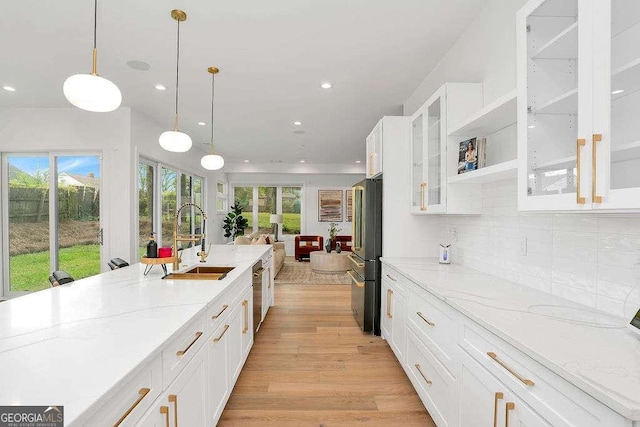 1598 Athens Ave SW, Atlanta, GA 30310 - kitchen featuring freestanding refrigerator, light stone counters, light wood finished floors, recessed lighting, and white cabinetry