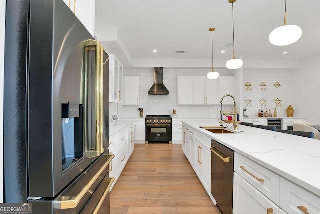 1598 Athens Ave SW, Atlanta, GA 30310 - kitchen with appliances with stainless steel finishes, wall chimney exhaust hood, white cabinets, backsplash, and pendant lighting