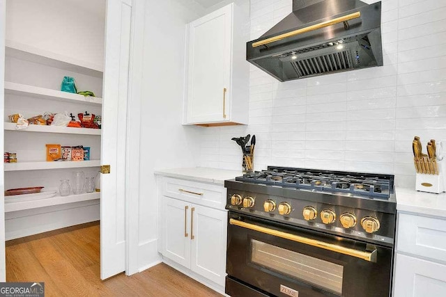 1598 Athens Ave SW, Atlanta, GA 30310 - kitchen featuring gas stove, custom exhaust hood, white cabinets, tasteful backsplash, and light wood-type flooring