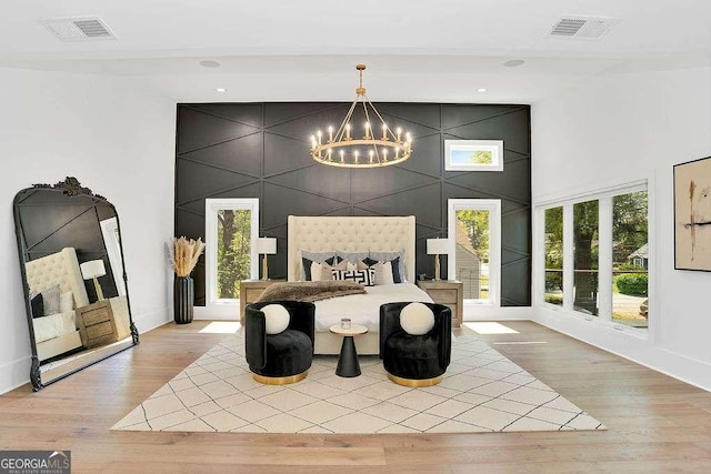 1598 Athens Ave SW, Atlanta, GA 30310 - bedroom with a chandelier, wood finished floors, an accent wall, and a towering ceiling