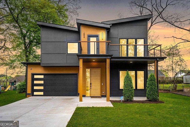 1598 Athens Ave SW, Atlanta, GA 30310 - contemporary house with a balcony, an attached garage, driveway, and a front lawn