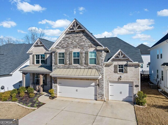 127 Crest Brooke Dr, Canton, GA 30115 - craftsman house featuring a standing seam roof, metal roof, stone siding, an attached garage, and driveway