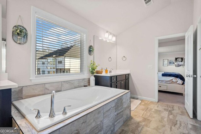 127 Crest Brooke Dr, Canton, GA 30115 - ensuite bathroom with vanity, vaulted ceiling, ensuite bath, visible vents, and a bath