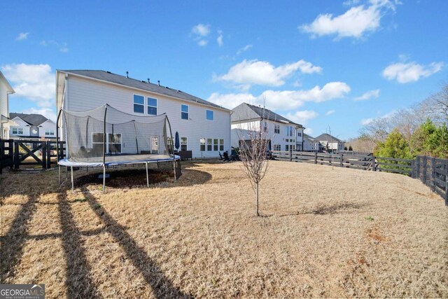 127 Crest Brooke Dr, Canton, GA 30115 - rear view of property featuring fence and a trampoline