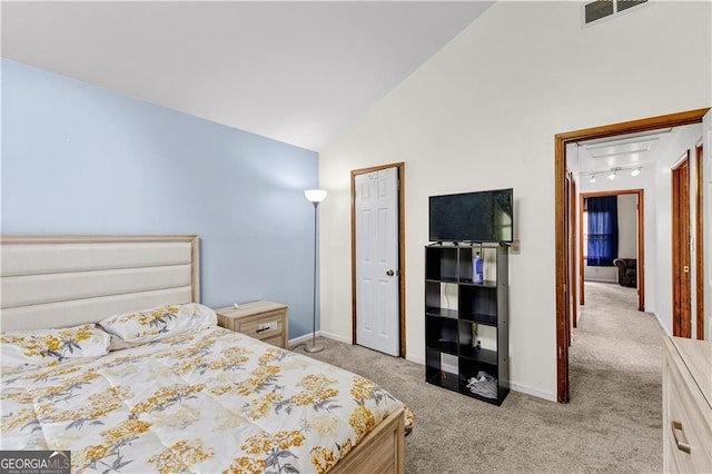 5429 Golfcrest Cir, Stone Mountain, GA 30088 - bedroom featuring visible vents, baseboards, rail lighting, light carpet, and vaulted ceiling