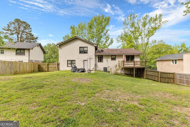 5429 Golfcrest Cir, Stone Mountain, GA 30088 - back of property with a lawn, a fenced backyard, a wooden deck, and stairway