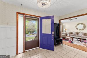 5429 Golfcrest Cir, Stone Mountain, GA 30088 - foyer featuring light tile patterned floors and wainscoting