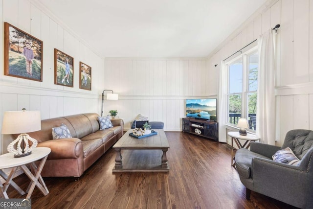 living room with crown molding and wood finished floors