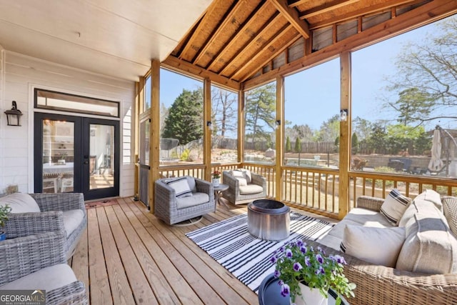 sunroom featuring an outdoor hangout area and french doors
