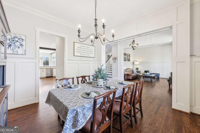 dining room with stairs, a notable chandelier, a decorative wall, and dark wood-style floors