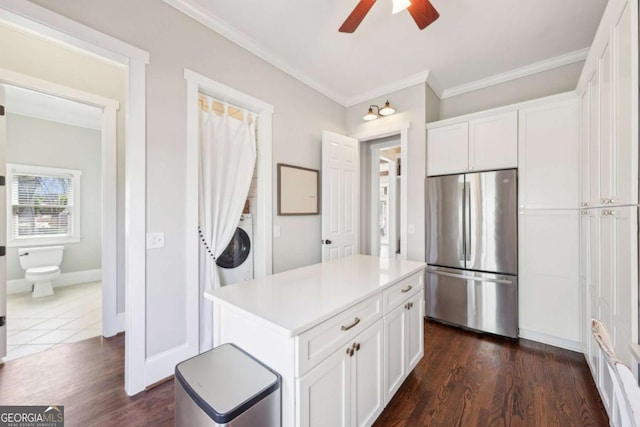 kitchen featuring a ceiling fan, freestanding refrigerator, dark wood-style floors, white cabinets, and ornamental molding