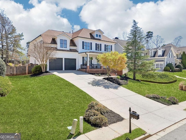 view of front of home featuring driveway, a garage, fence, and a front lawn