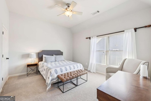 carpeted bedroom featuring baseboards, ceiling fan, visible vents, and vaulted ceiling