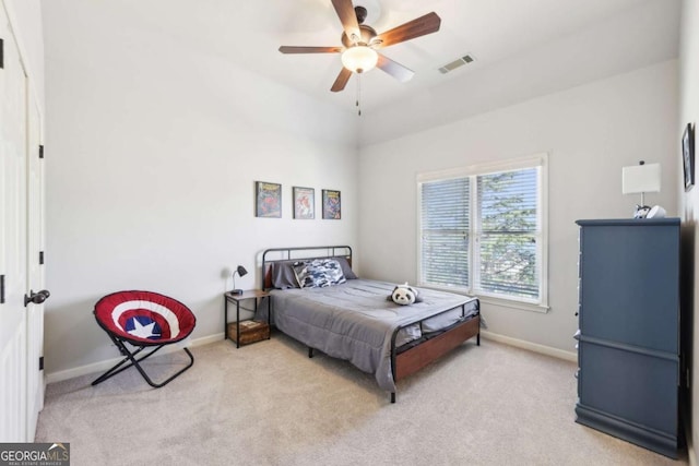 bedroom featuring baseboards, ceiling fan, visible vents, and carpet