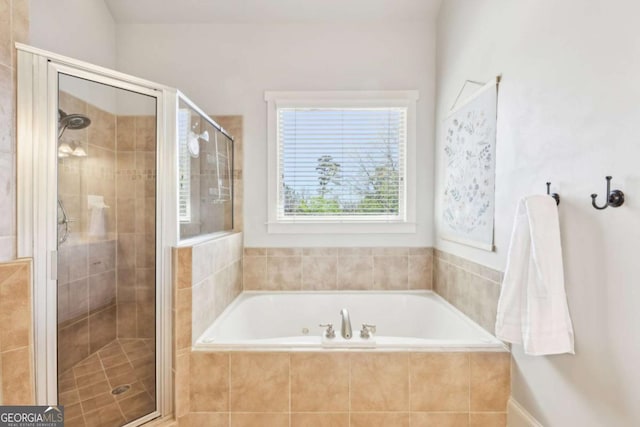 full bath featuring a shower stall and a garden tub
