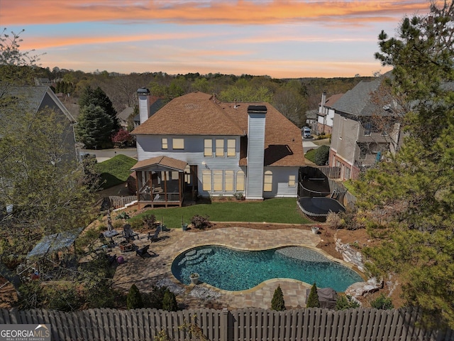 exterior space with a lawn, a fenced in pool, a fenced backyard, and a patio area