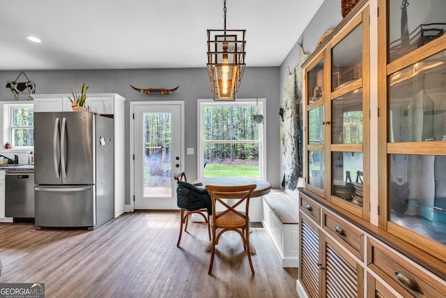 dining space featuring wood finished floors and recessed lighting