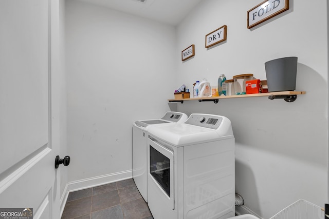 laundry area featuring baseboards, separate washer and dryer, and laundry area