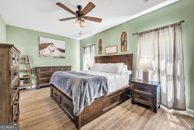 bedroom with a ceiling fan and light wood finished floors