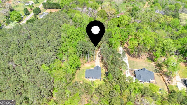 drone / aerial view featuring a forest view
