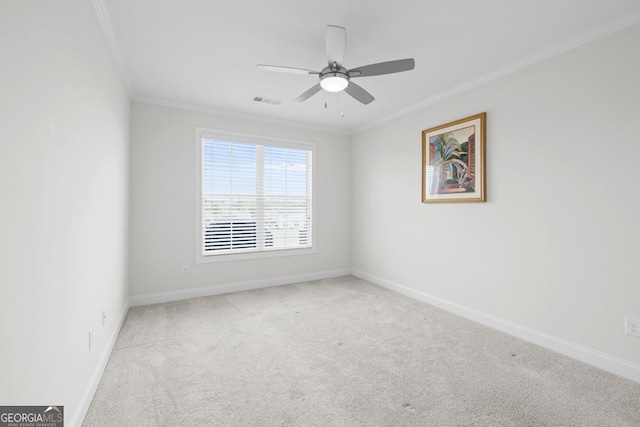 carpeted empty room featuring ceiling fan, baseboards, ornamental molding, and visible vents