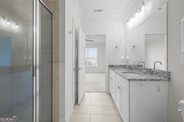 bathroom with a sink, double vanity, visible vents, a shower stall, and crown molding