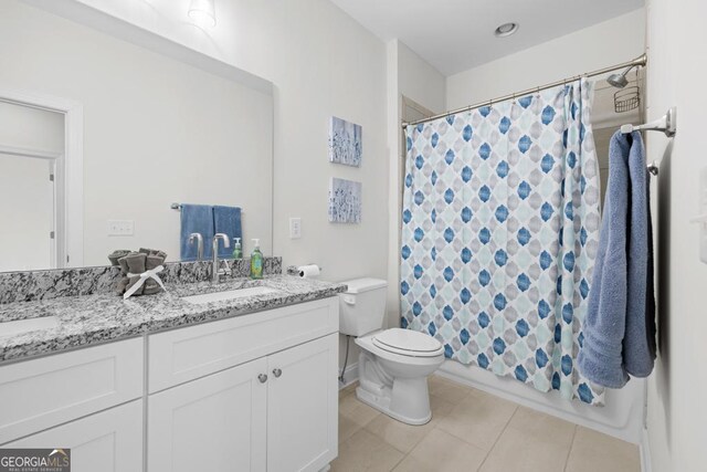 bathroom with tile patterned flooring, a shower with curtain, toilet, and a sink