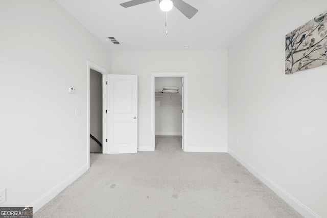 unfurnished bedroom with carpet floors, visible vents, and baseboards