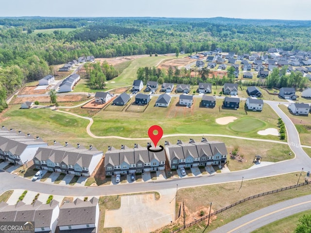 birds eye view of property with a residential view, golf course view, and a forest view