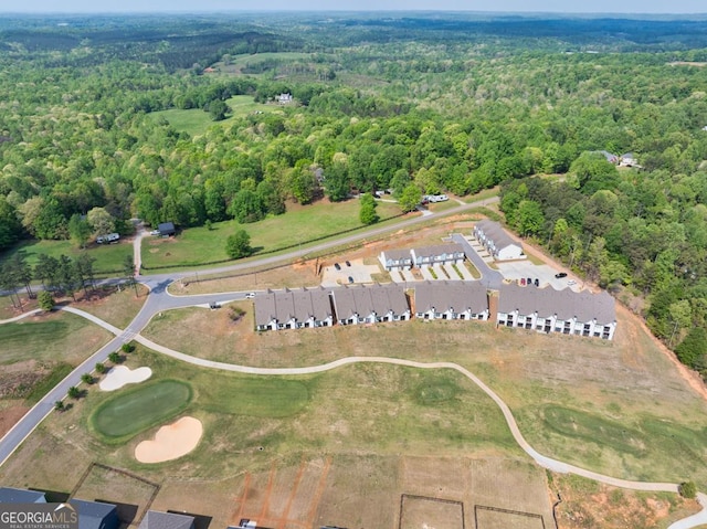 aerial view with view of golf course and a view of trees
