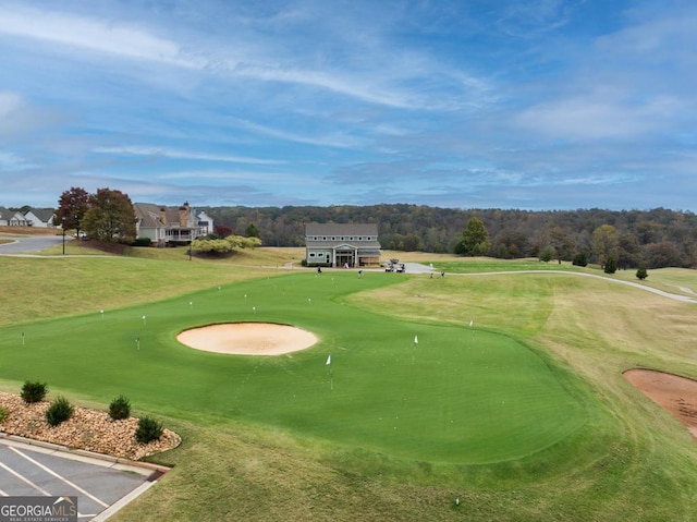 surrounding community featuring a lawn and golf course view