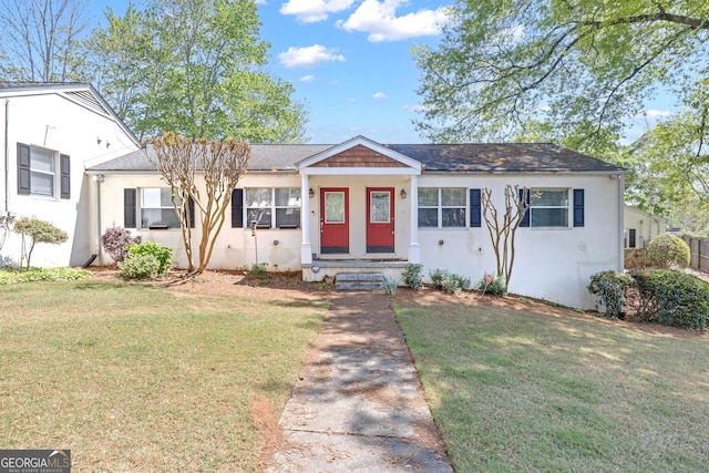 view of front of home with a front yard and stucco siding