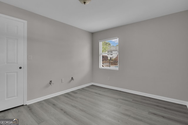unfurnished room featuring baseboards and wood finished floors