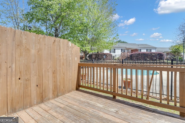 wooden terrace featuring fence