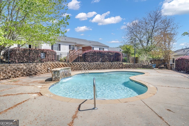 view of swimming pool with fence, a fenced in pool, and a patio