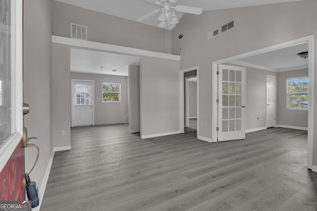 interior space featuring a healthy amount of sunlight, visible vents, wood finished floors, and ceiling fan