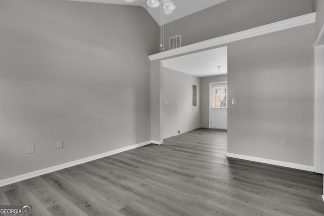 spare room with wood finished floors, baseboards, a ceiling fan, and visible vents