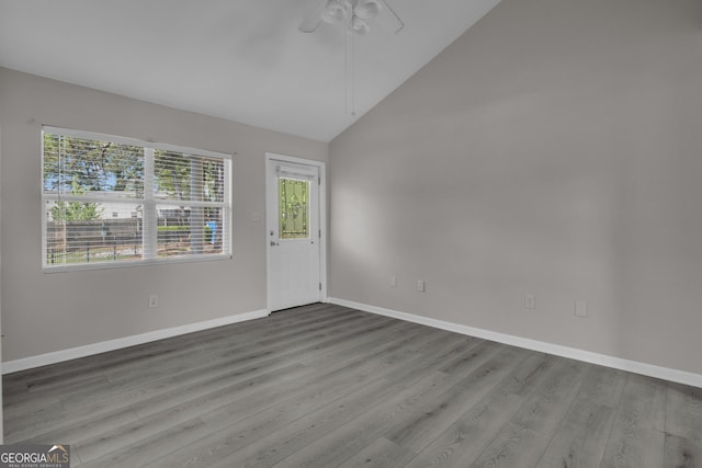 entryway featuring ceiling fan, high vaulted ceiling, wood finished floors, and baseboards