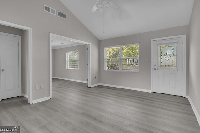 entryway featuring baseboards, light wood-style flooring, a ceiling fan, visible vents, and high vaulted ceiling