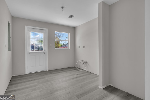 interior space with light wood-type flooring and electric panel
