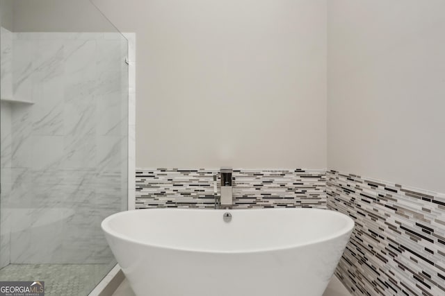 828 Canterbury Overlook NE, Atlanta, GA 30324 - bathroom with tile walls, a soaking tub, a sink, wainscoting, and a shower stall