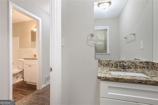 5052 Mountain St, Stone Mountain, GA 30083 - bathroom with visible vents, toilet, and vanity