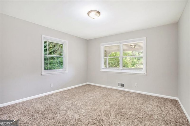 5052 Mountain St, Stone Mountain, GA 30083 - carpeted empty room with baseboards and visible vents