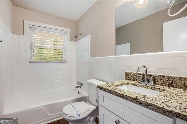 5052 Mountain St, Stone Mountain, GA 30083 - bathroom featuring tile walls, toilet, shower / tub combination, and vanity