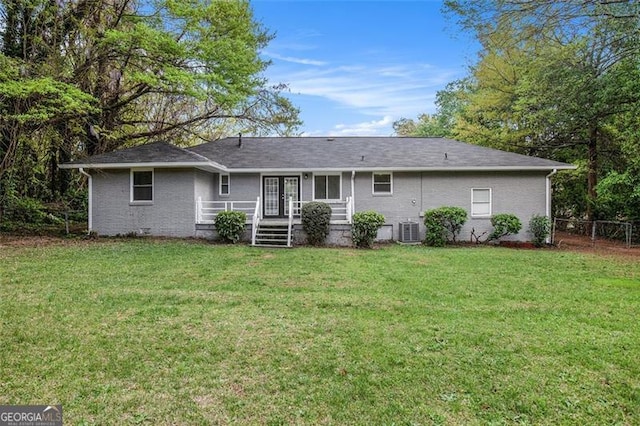 5052 Mountain St, Stone Mountain, GA 30083 - rear view of house with central AC unit, fence, brick siding, french doors, and a yard