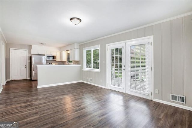 5052 Mountain St, Stone Mountain, GA 30083 - unfurnished living room with dark wood-type flooring, ornamental molding, visible vents, and french doors